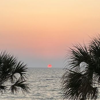 SeaGuini - Opal Sands Resort - Sunset view from the pool area outside the restaurant. - New American Near Me - Clearwater, Florida