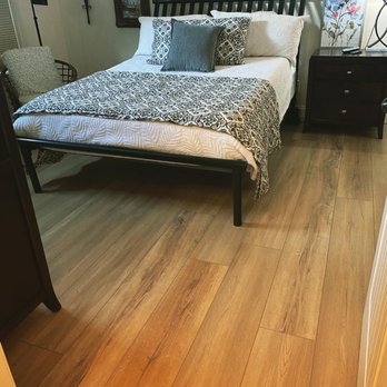Flooring Gurus - a bed in a bedroom - Flooring Near Me - Pelham, Alabama