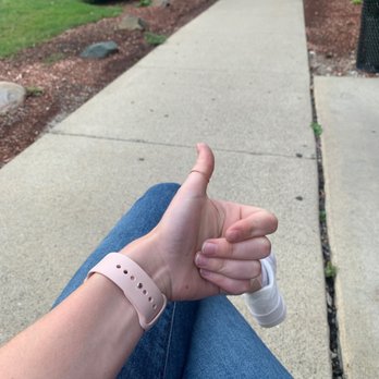 Mobil - a person sitting on a sidewalk giving a thumbs up - Convenience Stores Near Me - Rochester Hills, Michigan