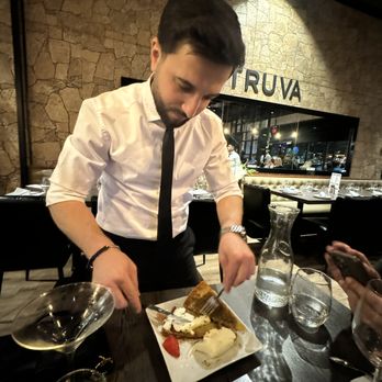 Truva Turkish Kitchen - Our server preparing special baklava with Turkish ice cream - so rich and fabulous. - Turkish Near Me - Cincinnati, Ohio Truva Turkish Kitchen - Our server preparing special baklava with Turkish ice cream - so rich and fabulous. - Turkish Near Me - Cincinnati, Ohio