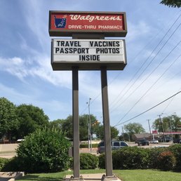 a sign for travel vaccines passport photos inside a sign for travel vaccines passport photos inside