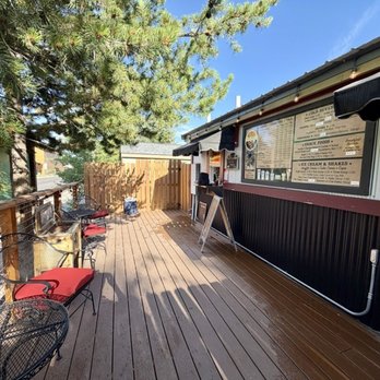 Espresso West Bake Shop - The patio has 3 tables, 6 seats, and some shade. - Coffee & Tea Near Me - West Yellowstone, Montana