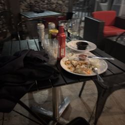 Social Kitchen + Bar - Table with piled dishes.