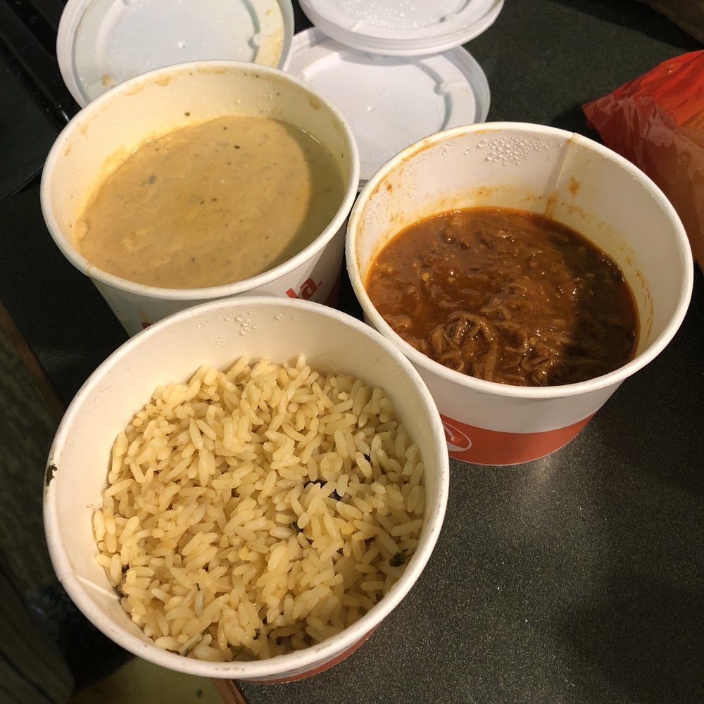three bowls of soup and rice on a counter
