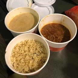 three bowls of soup and rice on a counter three bowls of soup and rice on a counter