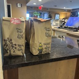To go breakfast bags with fun artwork done by staff. To go breakfast bags with fun artwork done by staff.