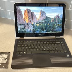 This laptop went from being painfully slow to seemingly brand new after we replaced the hard drive with an SSD. Old drive pictured left.