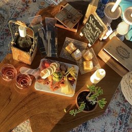 Charcuterie board with a wine you get to pick! Also has a tic-tack-toe game and a deck of cards