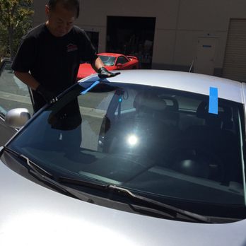 Shield X - Owner making sure the windshield was held in place for so the auto glue would properly set. - Windshield Installation & Repair Near Me - Oceanside, California Shield X - Owner making sure the windshield was held in place for so the auto glue would properly set. - Windshield Installation & Repair Near Me - Oceanside, California
