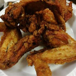 fried chicken wings on a paper plate