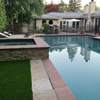 Blue Water Pools - a pool surrounded by green grass - General Contractors Near Me Blue Water Pools - a pool surrounded by green grass - General Contractors Near Me