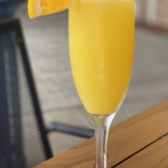 Short Stacks - a glass of orange juice on a table - Breakfast & Brunch Near Me - Wellington, Florida