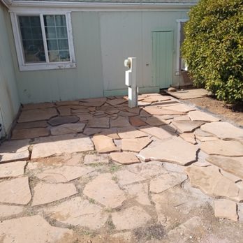Atomic Landscaping - Laying down flagstone - Landscaping Near Me Atomic Landscaping - Laying down flagstone - Landscaping Near Me