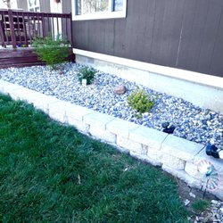 Lopez Lawns - Retaining wall added with rocks replaced mulch.