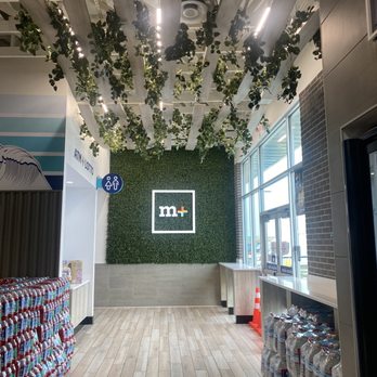Chevron - the inside of a building with plants hanging from the ceiling - Gas Stations Near Me - Sacramento, California