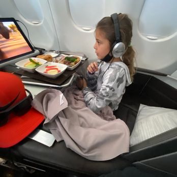 Hawaiian Airlines - Daughter eating watching a movie on the plane - Airlines Near Me - San Diego, California Hawaiian Airlines - Daughter eating watching a movie on the plane - Airlines Near Me - San Diego, California