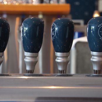 Four Winds Brewing - Closeup of beer taps - Mexican Near Me - Delta, British Columbia Four Winds Brewing - Closeup of beer taps - Mexican Near Me - Delta, British Columbia