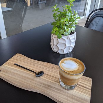 Cast Iron Coffee - a cup of cappuccino and a spoon - Coffee & Tea Near Me - DeKalb, Illinois