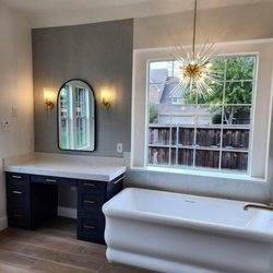 HDP Construction Services - Modern bathtub with giant window and custom made vanity area