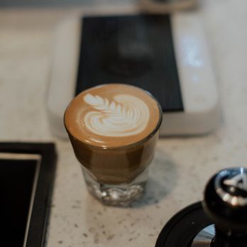 Bloom Coffee & Kitchen - americano with  flower made by Niki - Coffee & Tea Near Me - Roseville, California