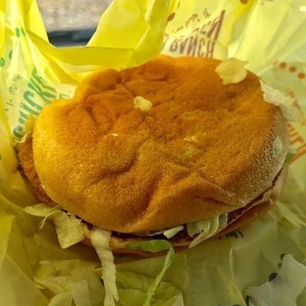 a hamburger in a wrapper a hamburger in a wrapper