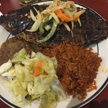 Gorée Cuisine - House Tiebu Djeun (Whole Tilapia with cabbage, carrots, and yucca; served over Djolof rice) - Senegalese Near Me - Chicago, Illinois Gorée Cuisine - House Tiebu Djeun (Whole Tilapia with cabbage, carrots, and yucca; served over Djolof rice) - Senegalese Near Me - Chicago, Illinois
