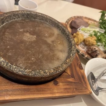 Pho Queen - Bun Bo Hue boiling and steaming broth in stone bowl - Vietnamese Near Me - Niagara Falls, Ontario Pho Queen - Bun Bo Hue boiling and steaming broth in stone bowl - Vietnamese Near Me - Niagara Falls, Ontario