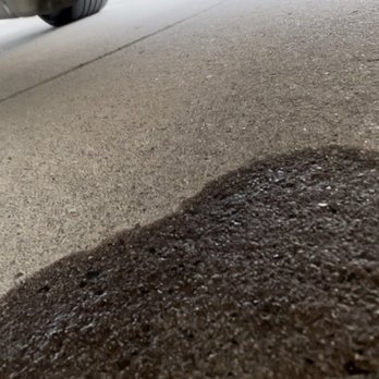 Neil Huffman Mazda - Puddle of gasoline on drive way - Car Dealers Near Me - Louisville, Kentucky