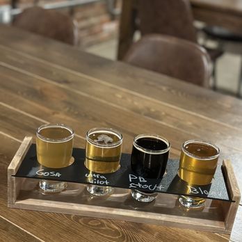 Frog Level Brewing - four glasses of beer on a tray - Beer Gardens Near Me - Waynesville, North Carolina
