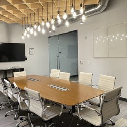 The Grid Works - KAWS Conference Room seats 10-12, TV is Chromecast, white boards and a mini fridge. Very private location in our space. Free park/bev/snacks