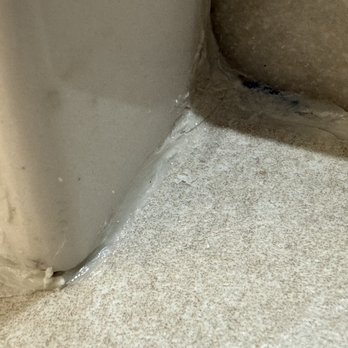 Ceramic Solutions - Bad silicone job done around shower curb - Flooring Near Me