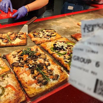 305 Pizza - a person cutting a slice of pizza - Pizza Near Me - Miami, Florida 305 Pizza - a person cutting a slice of pizza - Pizza Near Me - Miami, Florida