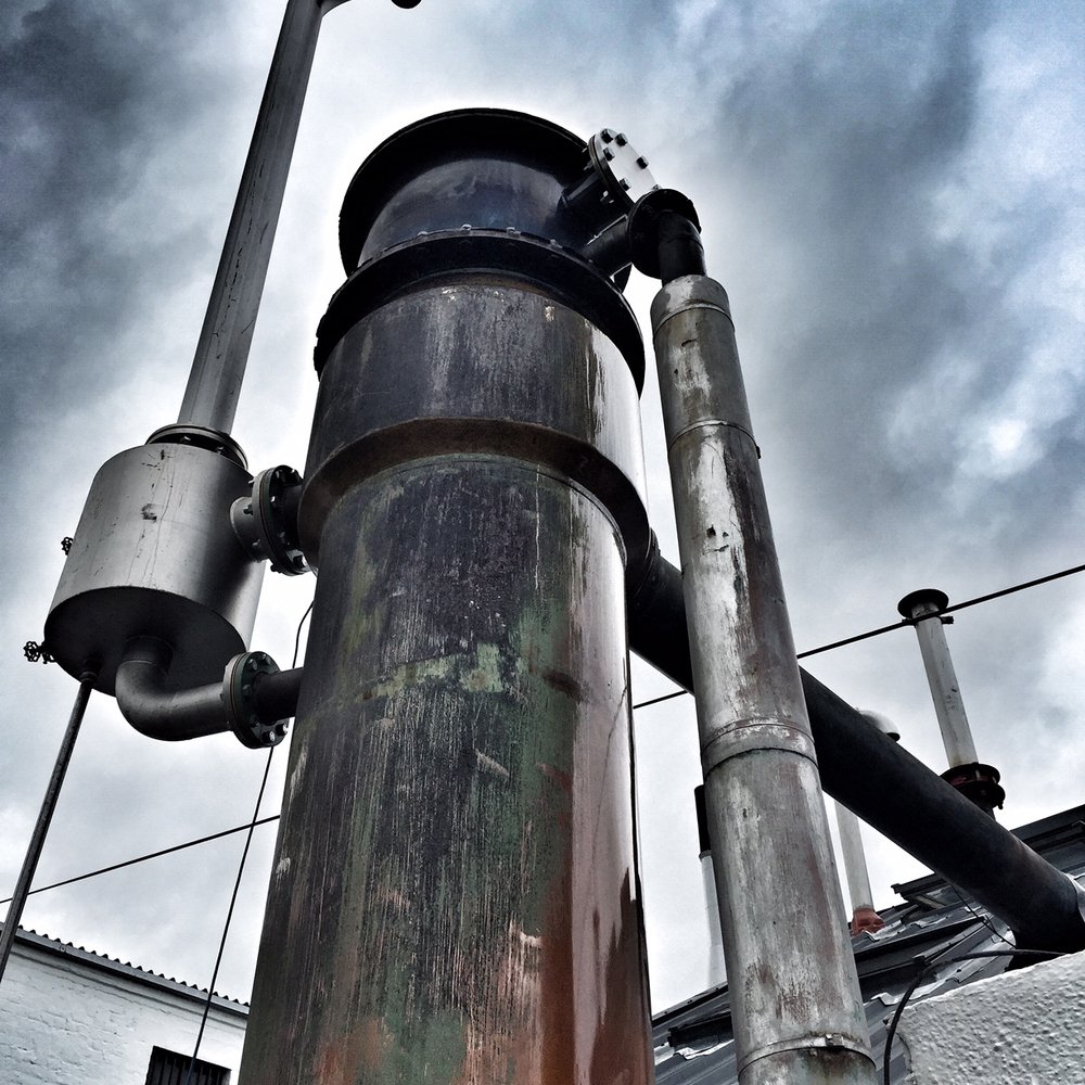 Morrison Bowmore Distillers - industrial bits against a bold sky - Beer, Wine & Spirits Near Me - Bowmore, AGB