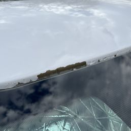 Paint falling off above the windshield.