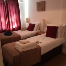Lamington Serviced Apartments - 2nd bedroom with two twin beds, closet, two side tables and a dresser.  Small but had nice sized closet and storage.