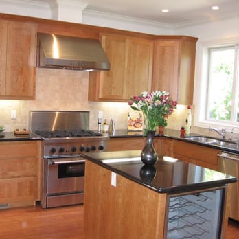 Camarina Construction Corporation - a kitchen with wood cabinets and stainless steel appliances - General Contractors Near Me Camarina Construction Corporation - a kitchen with wood cabinets and stainless steel appliances - General Contractors Near Me