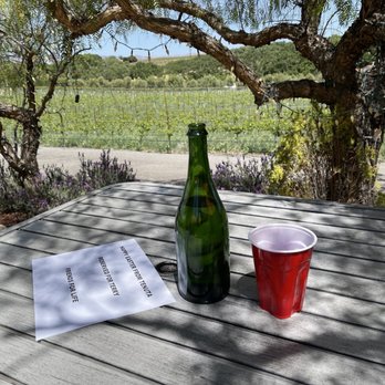 Tenuta Vineyards - a bottle of wine and a cup on a table - Wineries Near Me - Livermore, California Tenuta Vineyards - a bottle of wine and a cup on a table - Wineries Near Me - Livermore, California