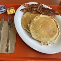 2 pancakes and a side of bacon (4 slices come in the side), with butter and blackberry jam.