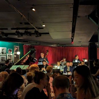 Village Vanguard - a group of people sitting in a bar - Jazz & Blues Near Me - New York, New York Village Vanguard - a group of people sitting in a bar - Jazz & Blues Near Me - New York, New York