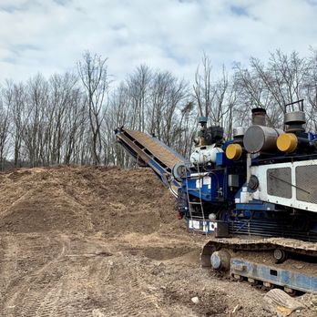 Metro Ground Covers - a large machine in the middle of a dirt field - Landscaping Near Me - Clarksburg, Maryland Metro Ground Covers - a large machine in the middle of a dirt field - Landscaping Near Me - Clarksburg, Maryland