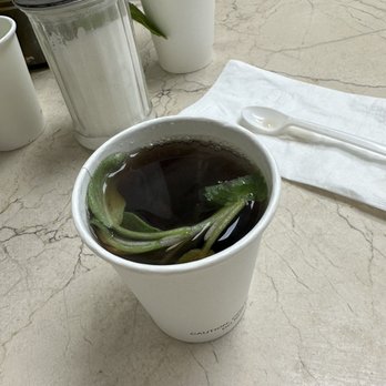 Fatayer - a cup of hot tea with a leaf in it - Lebanese Near Me - Richardson, Texas