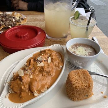 Agave Mexican Bistro - La Llorona pitcher, steak nachos with guac and pico on the side.  Chicken with 100 year old recipe sauce. - Mexican Near Me - Mountain View, California