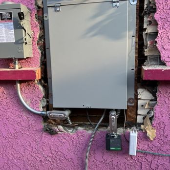 OC Solar - Note the ground wire coming out of the bottom of panel. Why isn't it fed through the wall so it comes out nearer to the foundation? - Solar Installation Near Me - Irvine, California OC Solar - Note the ground wire coming out of the bottom of panel. Why isn't it fed through the wall so it comes out nearer to the foundation? - Solar Installation Near Me - Irvine, California