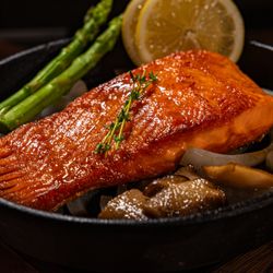 Woodam - "Fresh salmon perfectly grilled with teriyaki sauce, resulting in a moist and umami-rich dish."