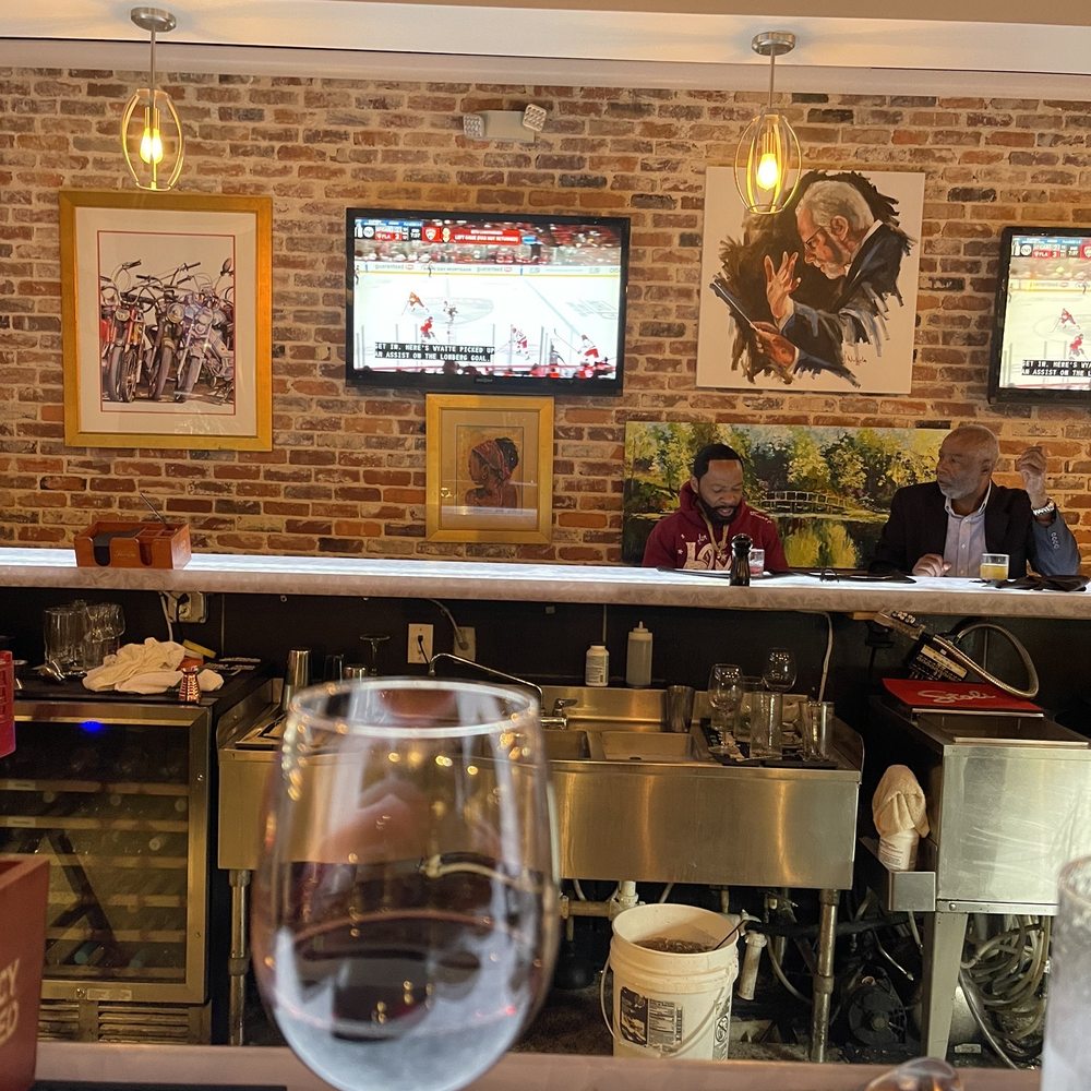 Victors - Bar photo- Red wine and hockey!! - New American Near Me - Florence, South Carolina Victors - Bar photo- Red wine and hockey!! - New American Near Me - Florence, South Carolina