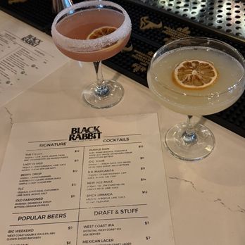 The Black Rabbit - Two signature drinks and a white menu on the bar counter. - Gastropubs Near Me - Stockton, California The Black Rabbit - Two signature drinks and a white menu on the bar counter. - Gastropubs Near Me - Stockton, California