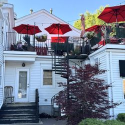 El Molcajete - View of their red patio umbrellas from the road