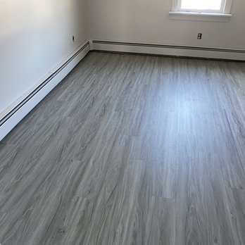 McCauley Flooring Installations - a room with wood floors - Flooring Near Me