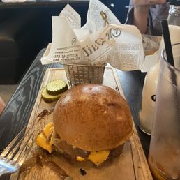 a burger on a wooden cutting board a burger on a wooden cutting board
