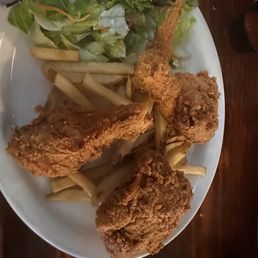 3 piece fried chicken with fries and a salad.